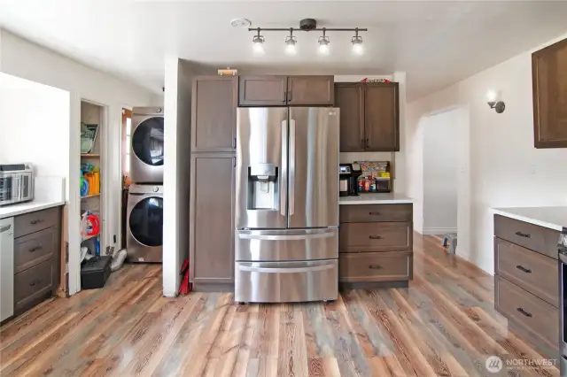 Washer and Dryer stow away on the main floor, beyond the kitchen, living room entry to the right