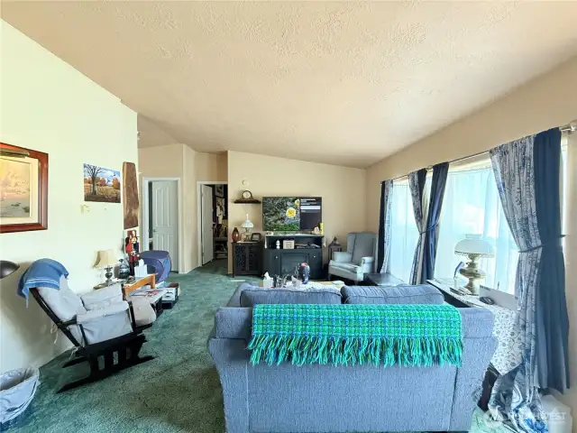 Living area looking towards guest bedroom, bath and office
