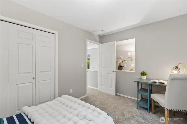 2nd bedroom with storage nook behind the door.