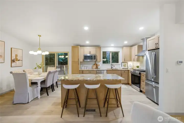 Entertaining kitchen with granite countertops, stainless steel appliances, including wine and beverage refrigerator.