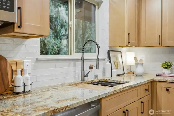 Workstation sink with pull-down faucet, custom tile backsplash and window surround