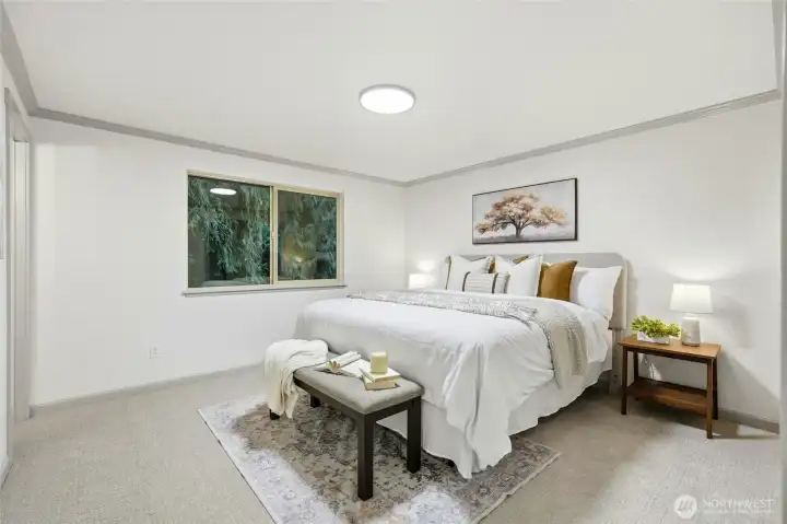 Primary bedroom with calming views into the trees of the secluded backyard