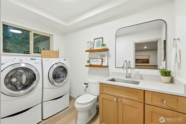Lower-level Utility/Laundry Room with 1/2 Bathroom, nice view into the private backyard.