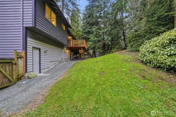 French drain directs water away from the home, gentle rolling slope of the secluded backyard