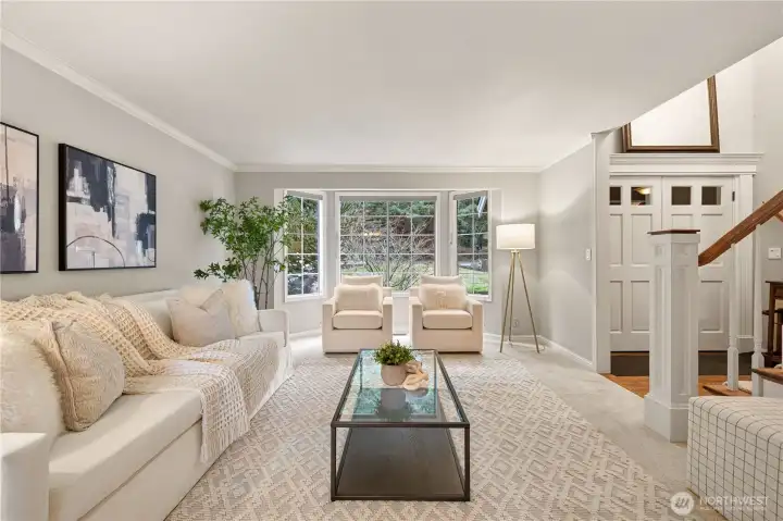 Welcome guests into a spacious, light-filled formal Living room with NEW carpet and a Charming Bay Window.
