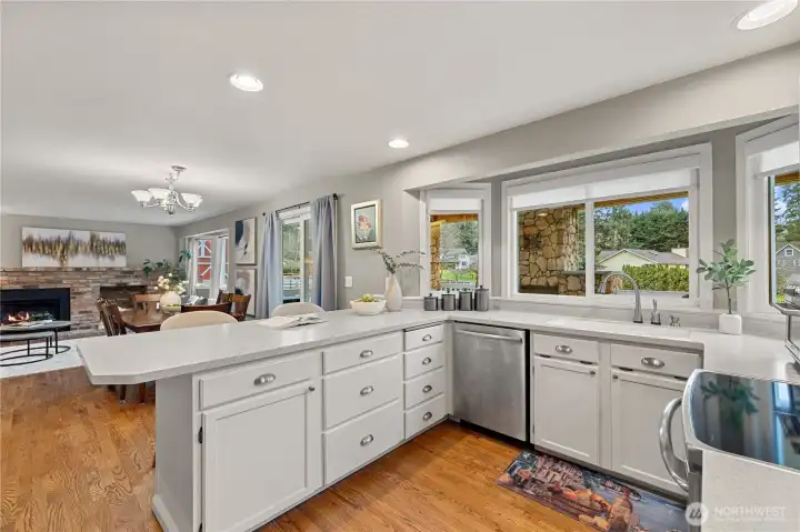 Open-concept kitchen featuring  Stainless Steel appliances, Hardwood floors, and seamless flow to the Family room.