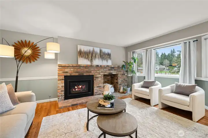 Relax in the spacious Family room with real hardwood floors, a cozy fireplace, and glass doors that lead to the Outdoor Living area for effortless year-round enjoyment.