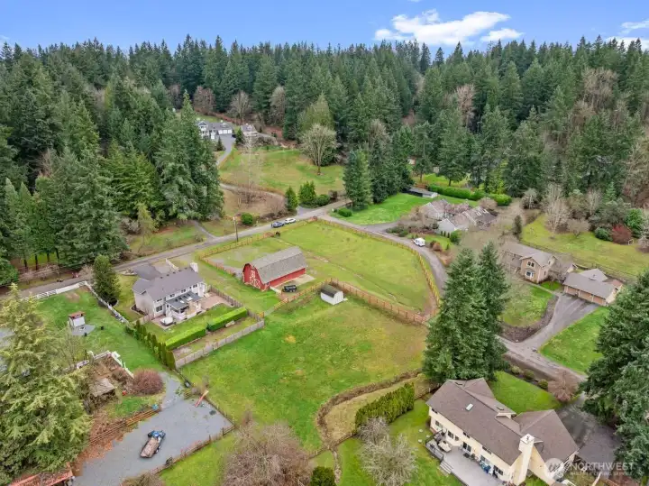 This is a view showing the Private pasture with most Newer Fencing. a HUGE Storage shed with a loft. The Barn has a shared pasture.  From the home, simply walk to the barn and ride out—an ideal setup for horse enthusiasts.