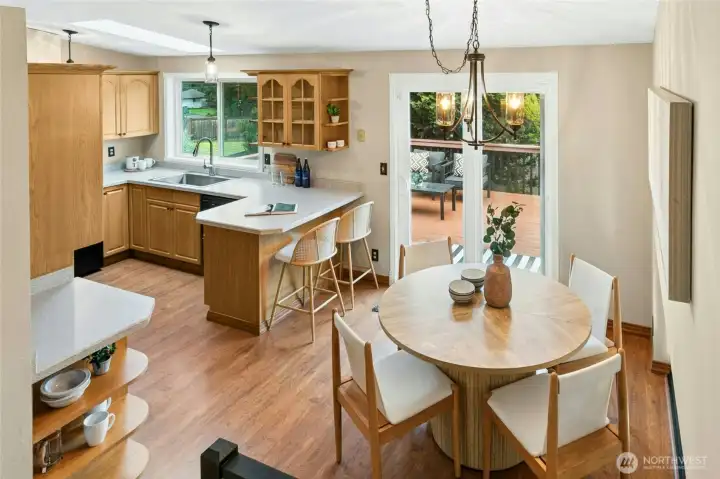 From the stairs this cheery South facing dining area and kitchen with views to the stunning fully landscaped backyard
