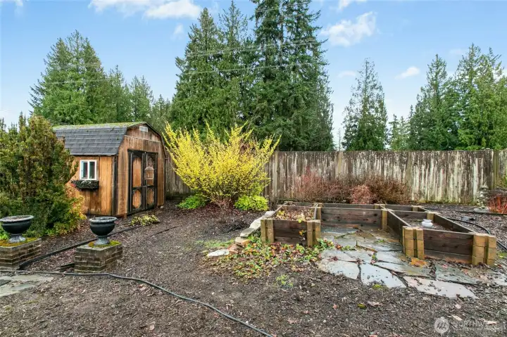 Large and beautiful shed and garden bed area.