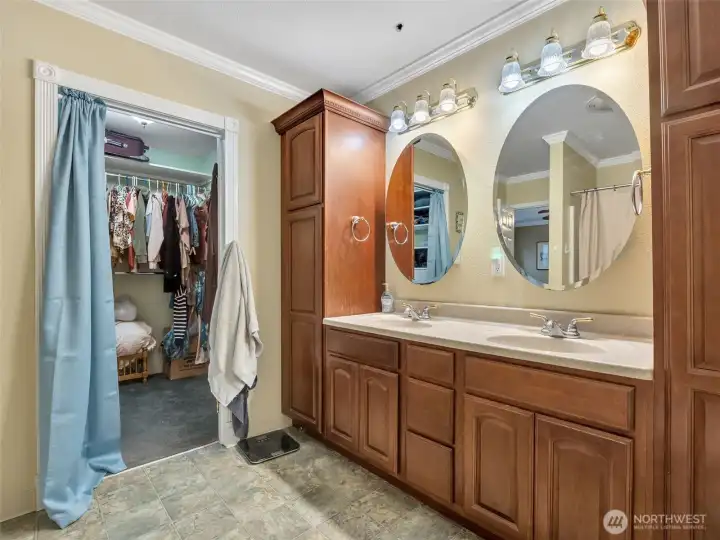 Double sinks, ample cabinets, and attached walk-in closet in the primary bath