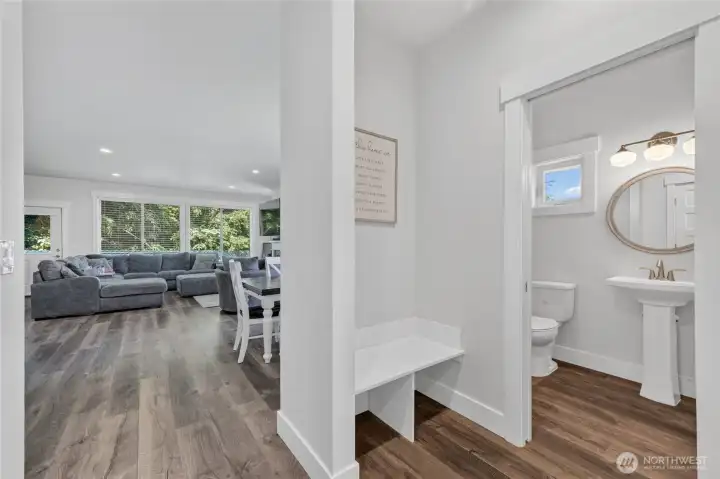 Look for entry into open living space. Powder bath is tucked in off front hall. Has a linen closet behind door. Just outside is great landing space and opposite built in bench is main floor laundry. Look for entry into open living space. Powder bath is tucked in off front hall. Has a linen closet behind door. Just outside is great landing space and opposite built in bench is main floor laundry.