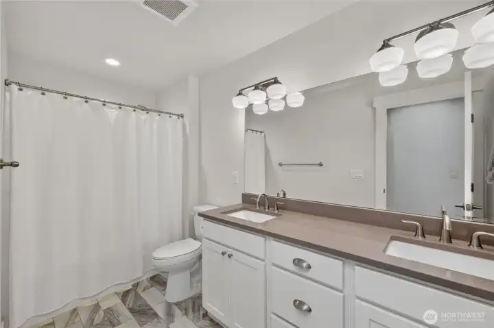 Secondary upper level bathroom with dual vanity. Secondary upper level bathroom with dual vanity.