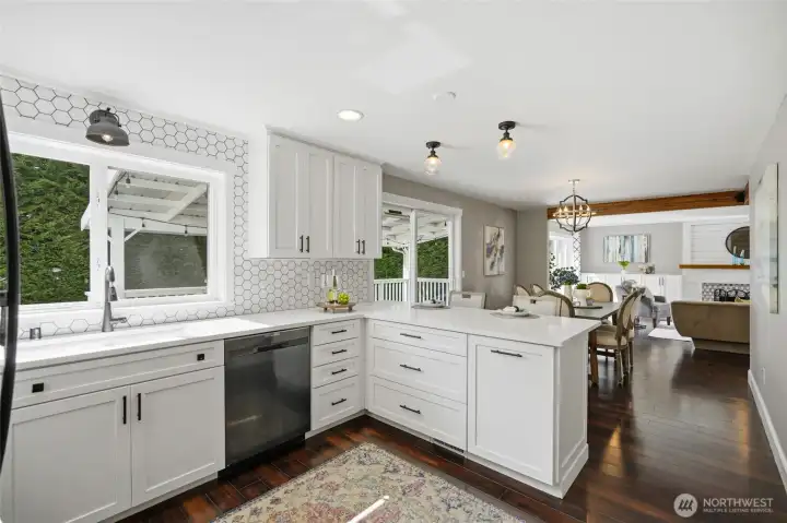 Bright, open kitchen with a large peninsula offering bar seating and storage on both sides.