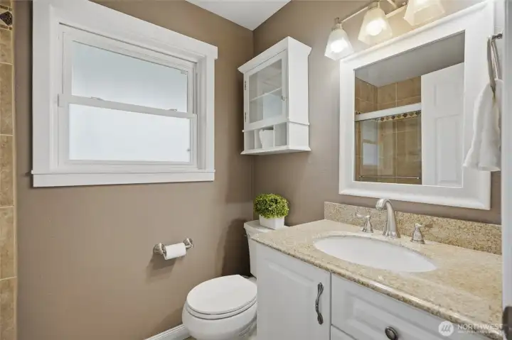 Full bathroom on the main level provides added convenience for guests and everyday living.
