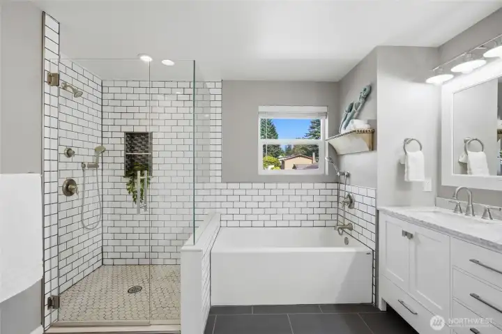 Remodeled 5-piece bathroom featuring a soaking tub, walk-in shower, dual sink vanity, and modern finishes.