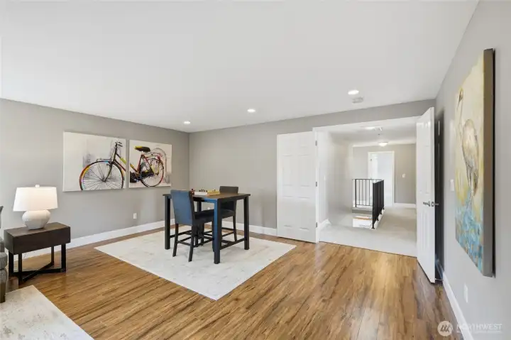 Double doors provide separation and privacy while connecting this expansive bonus room to the rest of the upper level.