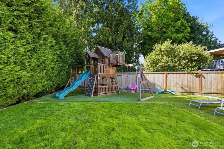 A dedicated play area with a play structure and artificial turf creates the perfect space for kids to play while keeping maintenance to a minimum.