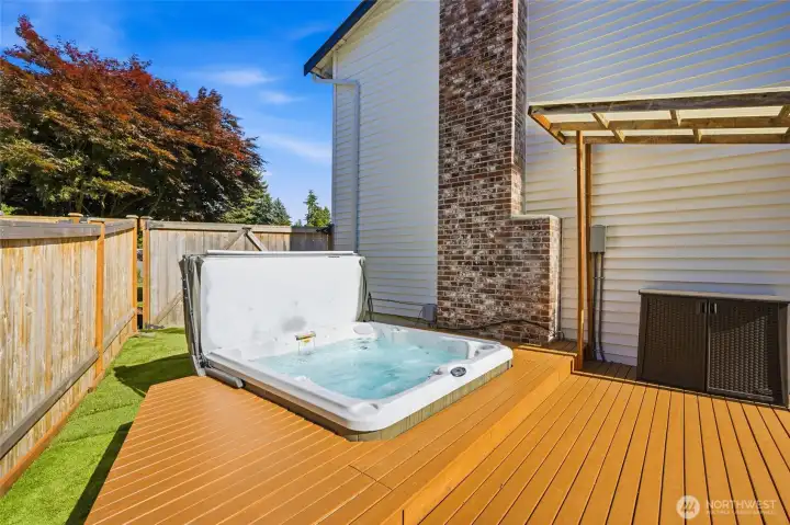 Unwind at the end of the day in the built-in hot tub, tucked away for added privacy and just steps from the covered deck.