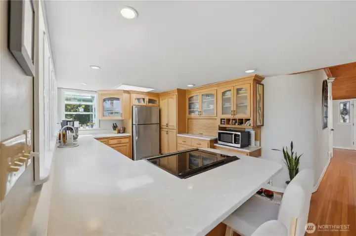 Custom cabinetry, quartz counters and stainless-steel appliances create an efficient and well-appointed kitchen. Custom cabinetry, quartz counters and stainless-steel appliances create an efficient and well-appointed kitchen.