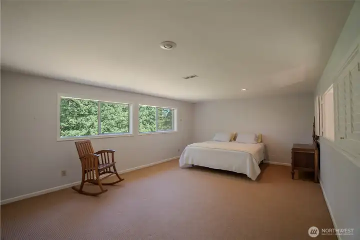 Primary bedroom with a peekaboo windo over the great room. Primary bedroom with a peekaboo windo over the great room.