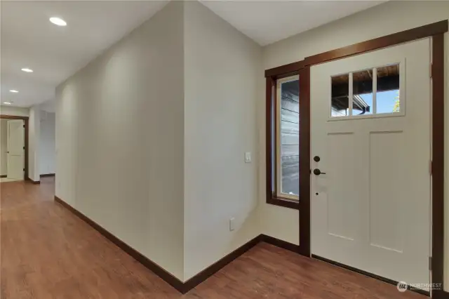Entryway boasts storage coat closet, a cover front porch, and a utility room that goes directly into the garage.