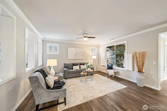 Living room with custom shutters and remote ceiling fan