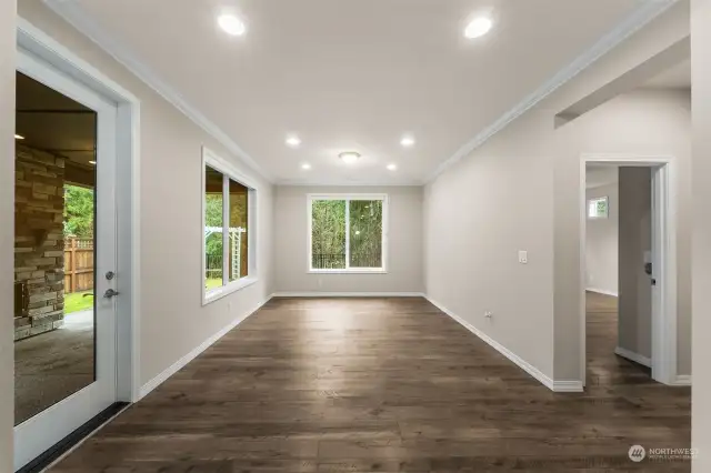 Dining Room with custom window coverings that hide away and easy access to the covered patio with gas fireplace for year around in door/out door entertainment