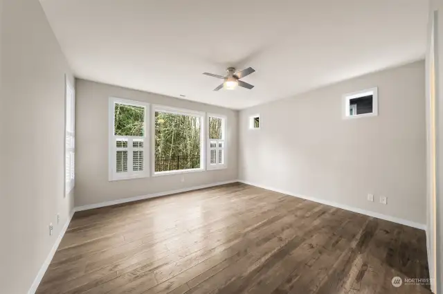 Primary bedroom with beautiful view of the green belt and custom shutters