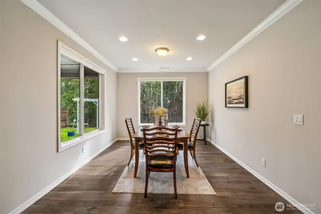 Dining Room with custom window coverings that hide away and easy access to the covered patio with gas fireplace for year around in door/out door entertainment