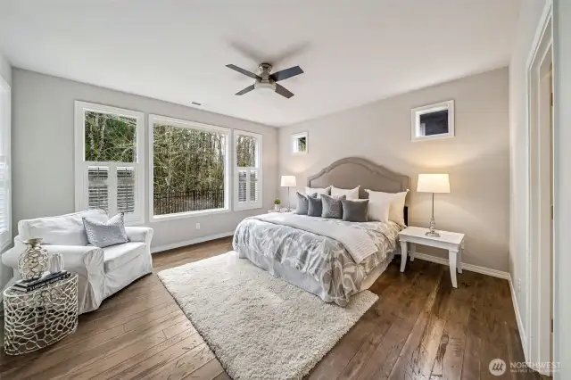 Primary bedroom with beautiful view of the green belt and custom shutters