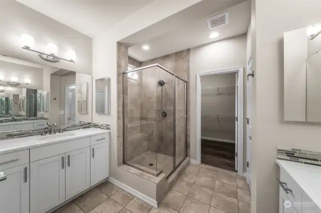 His and Her sinks on opposite walls, custom shower, walk in closet, and two linen closets.