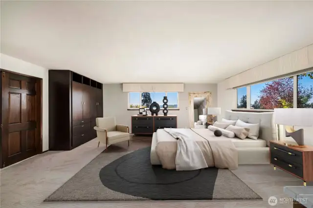Staging shows the potential of this oversized primary suite w/ sunset views