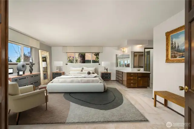 Staging shows the potential of this oversized primary suite w/ sunset views.