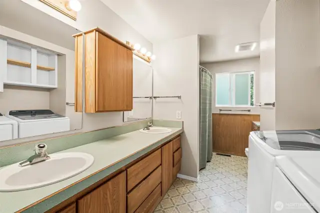 Upstairs full bathroom includes double sinks and laundry