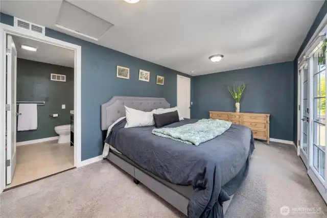 Primary bedroom with french doors to garden area