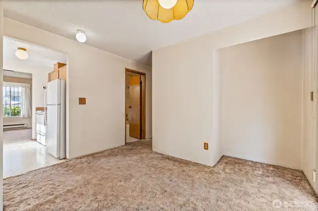 In the dining room looking toward the kithen and the bathroom.