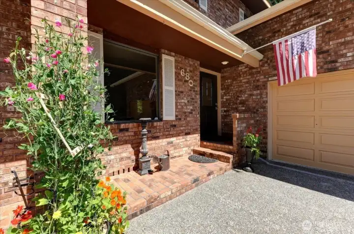 Covered front porch is a perfect place to display favorite pots of colorful flowers.