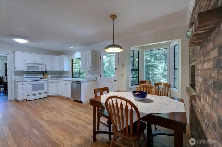 Breakfast nook sits right beside kitchen fireplace. Brick adds sooo much character!