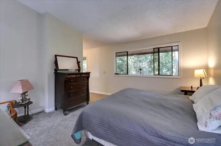 Primary bedroom overlooks back yard. King-sized bed leaves loads of room for additional furnishings.