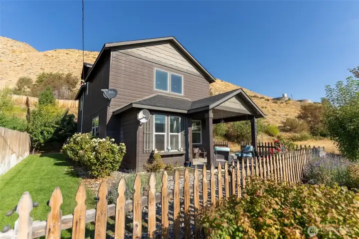 Charming 3-bedroom home with mountain views, a beautiful front yard, and a cozy covered porch.