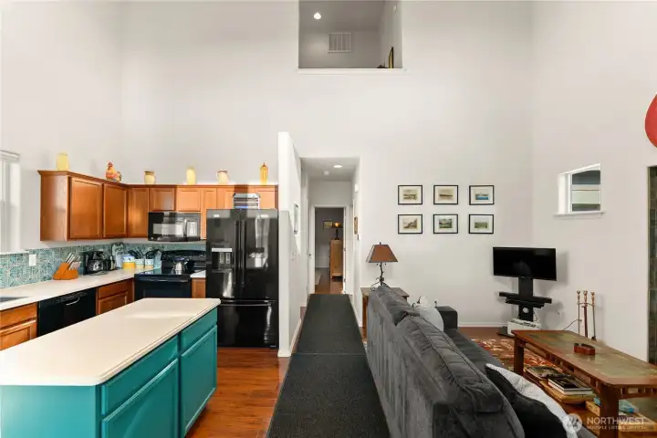 Through the front door, you're welcomed right into the heart of the home. Kitchen on the left, living space on the right.
