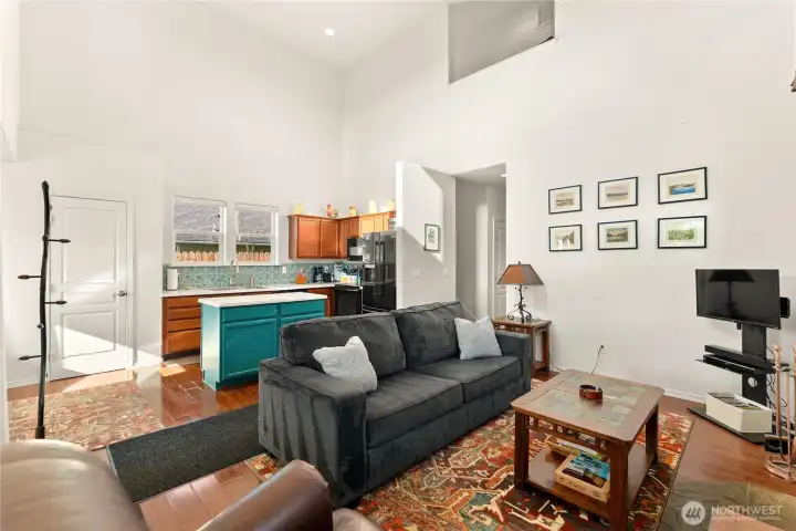 Open living area with soaring ceilings, perfect for entertaining. The seamless flow into the kitchen makes hosting a breeze.