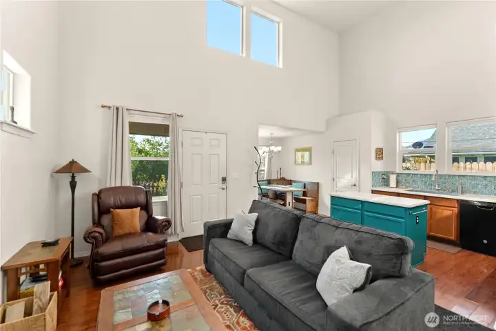 Inviting open living space bathed in natural light. The front door leads to a seamless flow into the kitchen and living area.
