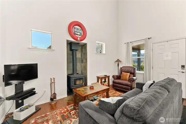Fully furnished living area with a cozy wood stove and comfortable seating. Well-appointed for relaxing or entertaining.