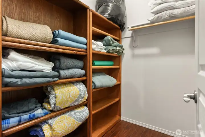 Walk-in closet in the main floor bedroom with plenty of shelving for organized storage.