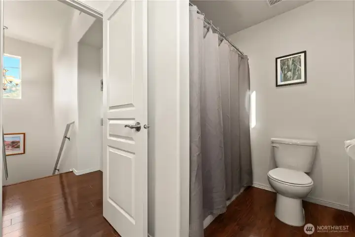 Upstairs bathroom with walk-in shower, modern fixtures, and plenty of natural light.