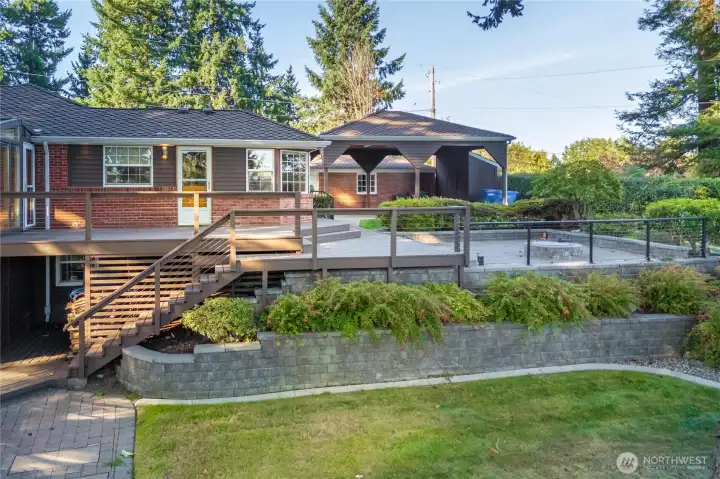 Another view of the wonderful outdoor entertaining space with the decks and the patio with a firepit.