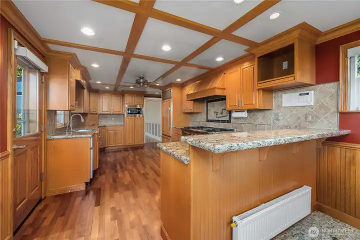 Gorgeous hardwood floors, granite counters, Wolf double ovens and cabinet-matching refrigerator are just some of the things you will love about this kitchen.