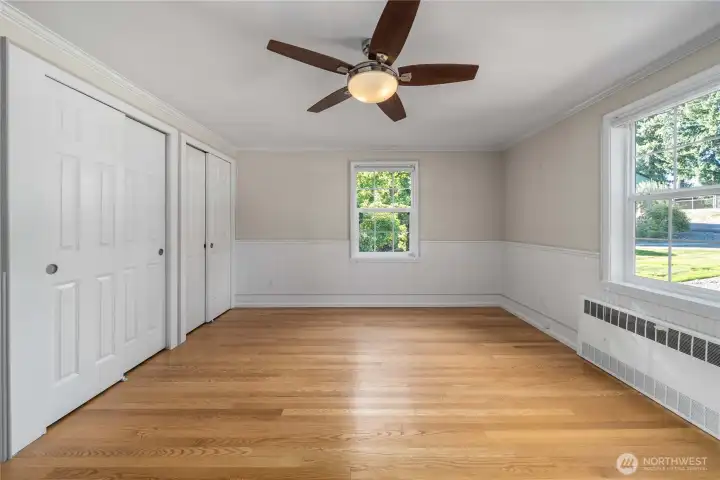Second main floor bedroom with double closets. This could be a main floor primary bedroom with a full bath in the hallway.